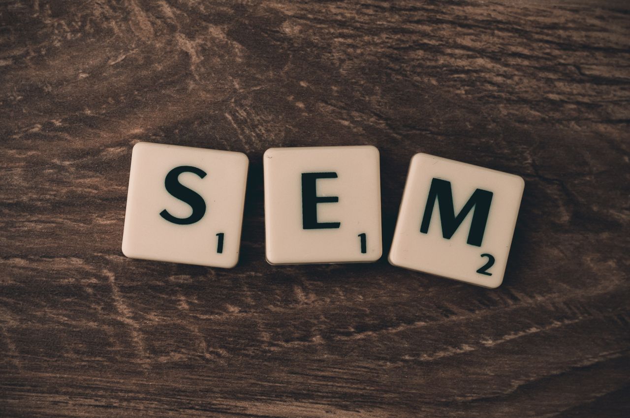 services-04 Wooden background with letter tiles spelling SEM, representing search engine marketing.